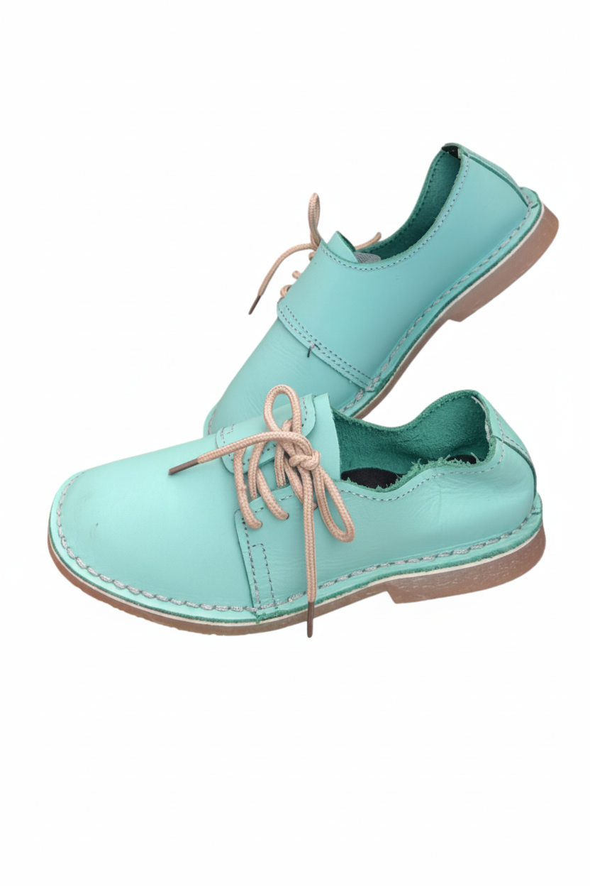Ladies leather side lace vellies in mint light green on a white background