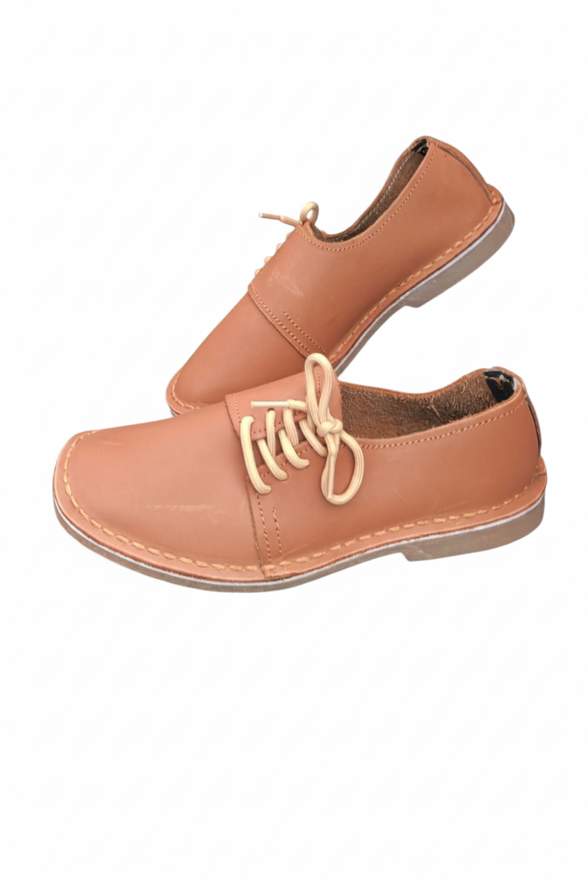 Ladies leather side lace vellies in tan on a white background