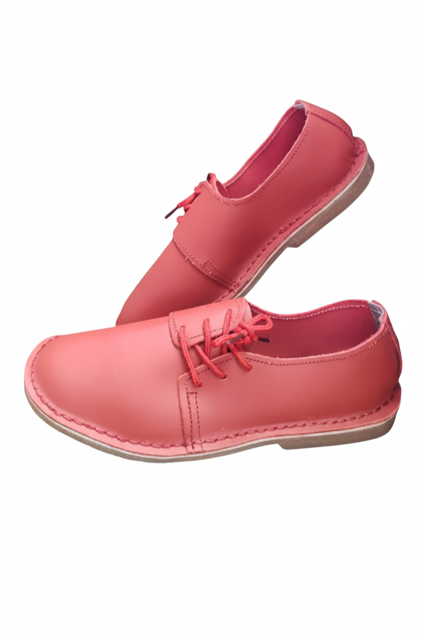 Ladies leather side lace vellies in red on a white background, side view